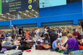 Tourists wait in the airport's departure hall as evacuations are underway due to wildfires, on the Greek island of Rhodes on July 23, 2023.