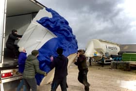 Giant blue head is carefully offloaded from its container.