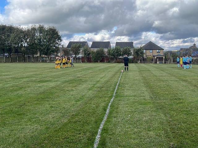 Players and officials show their respect at the Dove Holes v Bakewell Town match.