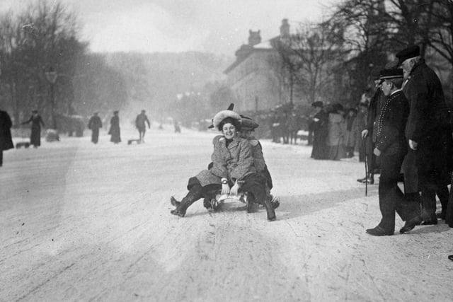 Two women is pictured Tobogganing in the snow at Buxton around 1904.