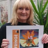Photographer Caroline Claye with the 2023 Fringe programme cover.