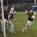 Josh Granite (centre) tries to clear as Banbury threaten on Saturday. Photo: BUFC.