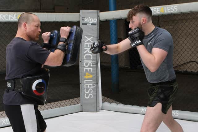 Tyler Spencer at work in the gym with his coach Jon  Santry. Pic Jason Chadwick
