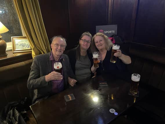 Three friends say 'Cheers' in The Queens. Photo The Queens Head Hotel