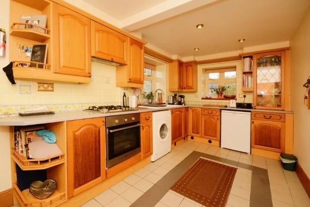 The kitchen is fitted with wall and floor storage cupboards, an integrated gas hob and there's space for a washing machine and dishwasher.