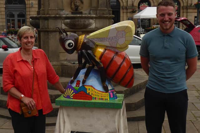 Billie the Buxton Bilberry bumblebee with artist Pam Smart and Potter’s Manager Matt Nuttall standing in front of Turner’s Memorial.