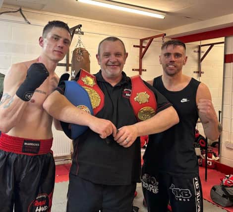 A very proud owner and trainer Ian Nolan with his champion ship fighters Liam Burke and Johnny Lowe