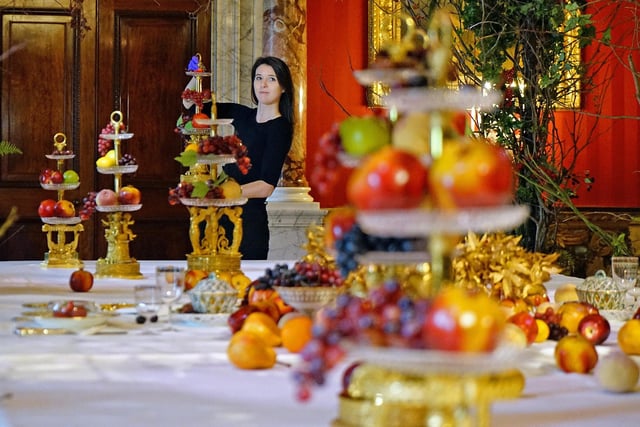 A worker puts the finishing touches to the table decoration in the Great Dining Room.