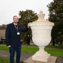 Councillor Damien Greenhalgh, Deputy Leader and Executive Councillor for Regeneration, Leisure and Tourism with the newly carved stone urn which has been installed on The Slopes in Buxton. Photo submitted