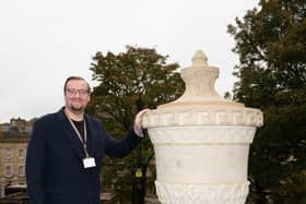 Councillor Damien Greenhalgh, Deputy Leader and Executive Councillor for Regeneration, Leisure and Tourism with the newly carved stone urn which has been installed on The Slopes in Buxton. Photo submitted