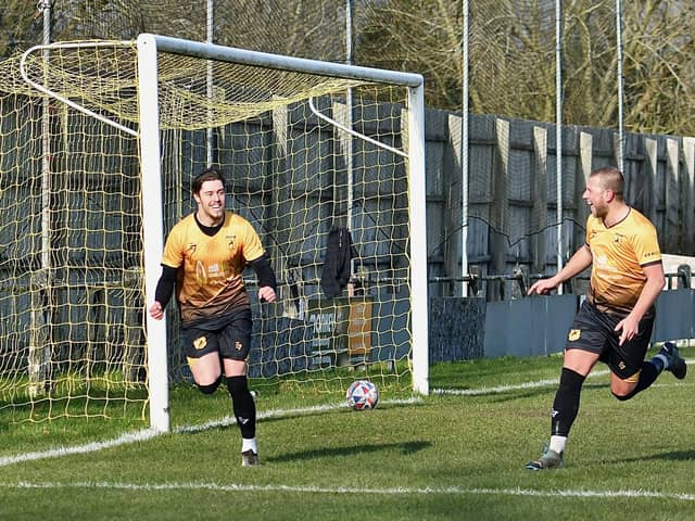 Harry Dean (left) and Chaz Whyte celebrate a crucial goal against Ashville. Photo by John Fryer.