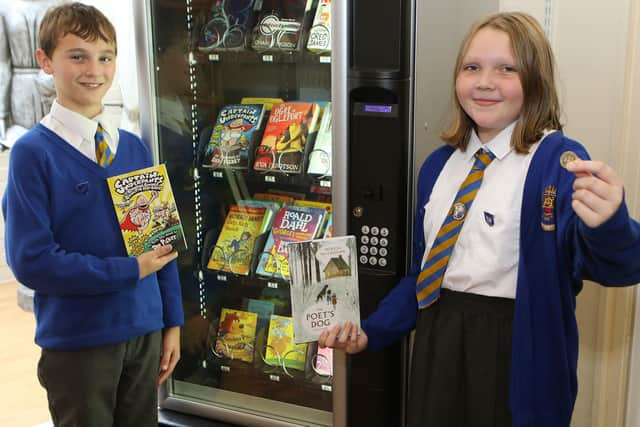 St Annes head boy Reuben Clay and head girl Grace Garner with the new book vending machine