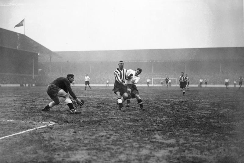 Derby defender Udall, keeps Spurs' Willie Evans at bay and allows Derby goalkeeper Kirby to collect the ball safely as Tottenham Hotspur play Derby County at White Hart Lane on 9th March 1935.