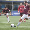 Jak McCourt tucks away a penalty for Buxton against Mickleover.