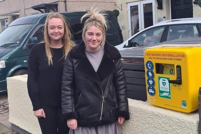 Janine Hall, right, and Kelly Jones with the new defibrillator on Aldwark Road.