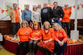 Picture shows Fringe team members in orange plus back row from left to right: singer and guitarist Charlie Moritz (in blue), singer-songwriter Danielle Banks, Fringe Chair Stephen Walker, comedian Henry Churniavsky and folk star Chris Milner - Journeyman. Picture credit: Darren Jackson.