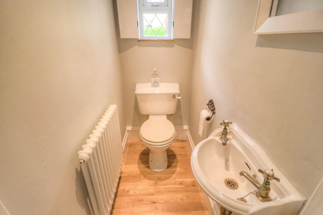 The downstairs cloakroom contains a white two-piece suite comprising wash basin and wc.