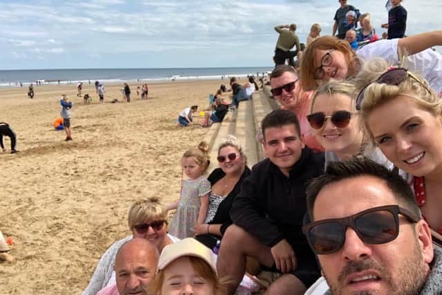 Steve surrounded by his loved ones at a day on the beach.