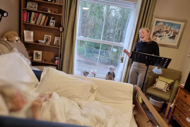 Katy often visits residents' bedsides to perform during her care home visits.