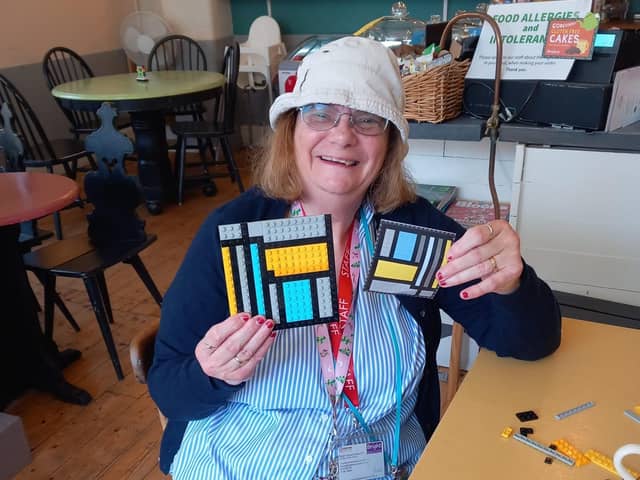 Members of Bright Opportunities decorating  Lego panels for the Wells Dressing board. Pic submitted