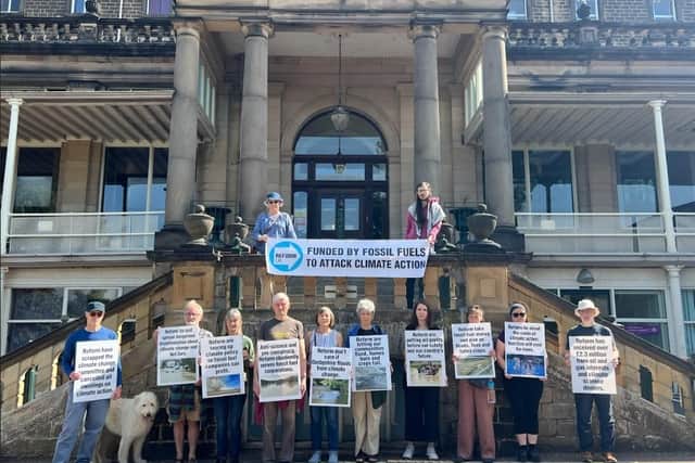 Campaigners held placards and banners with images of flooding, wildfires and ruined crops during the protest on Monday.