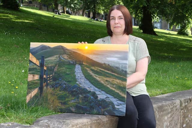 Helen Homer with one of her late husband's images which she is selling to raise money for Buxton Mountain Rescue Team