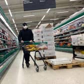 AS supermarket shopper wearing a mask in Finland (Photo by OLIVIER MORIN/AFP via Getty Images)
