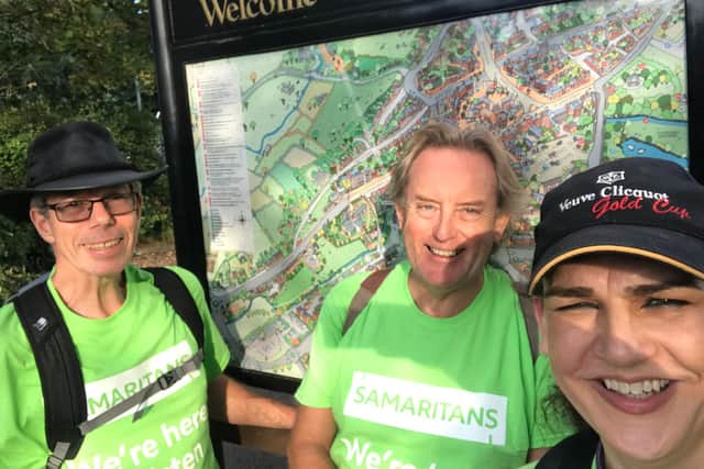 Ian Morris, middle, with two other volunteers during a walking marathon - which raised £4,000.