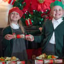 Ivy Dakin, 5, and Mia Dakin, 7, pull crackers.