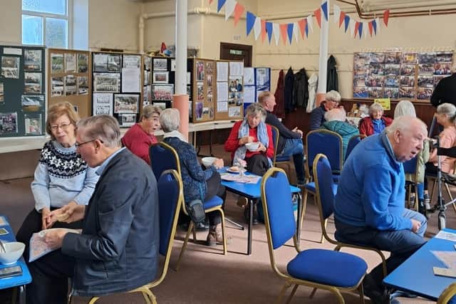 The community looking at the village archive during the open day and birthday celebrations of Dove Holes Methodist Church. Photo Rev'd Andrew Parker