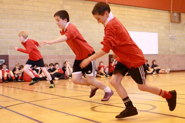 Boys take part in a sprint race during sports day.