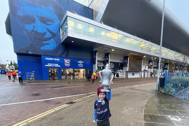 A young boy holds his trophy up high. Picture submitted