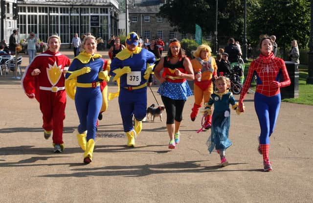 Superheroes on the run in front of the pavilion.