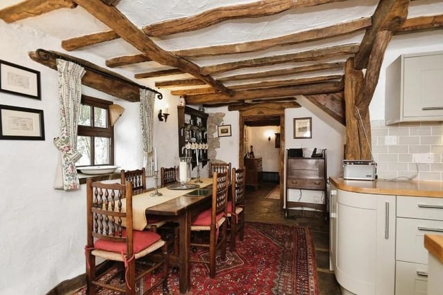 The dining room area has exposed beams to the ceiling and a stone flagged floor which leads through into the kitchen area. It has a double glazed window to the front with a stone sill and a cast iron central heating radiator.