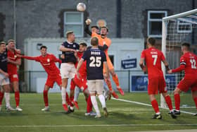 Joe Young punches clear for the visitors as Telford win at Buxton.