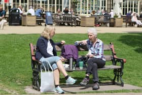 Two friends enjoying a catch up Buxton's Pavilion Gardens in the sun. Pic Jason Chadwick