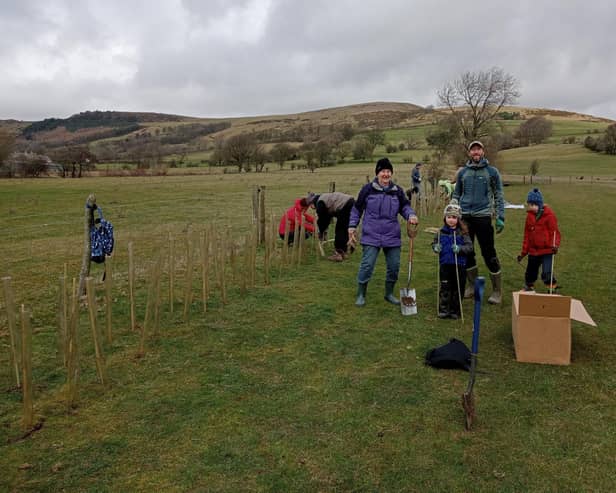Volunteers from Hope Valley Climate Action planting the new hedgerow at Marsh Farm.