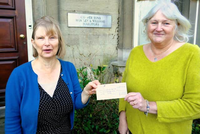 Anne Roberts (Samaritans) receives donation from Lindsay Crowe (Satterthwaite Bequest Trustee)