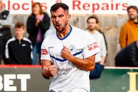 Diego De Girolamo scored twice in Buxton's replay with Kettering Town to see the Bucks through to the first round proper of the FA Cup.