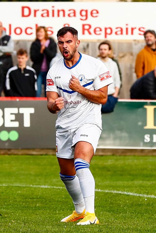 Diego De Girolamo scored twice in Buxton's replay with Kettering Town to see the Bucks through to the first round proper of the FA Cup.