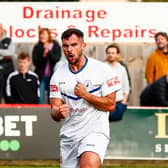 Diego De Girolamo scored twice in Buxton's replay with Kettering Town to see the Bucks through to the first round proper of the FA Cup