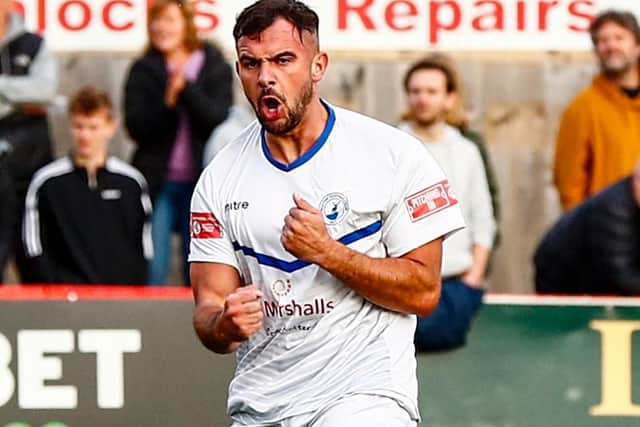 Diego De Girolamo scored twice in Buxton's replay with Kettering Town to see the Bucks through to the first round proper of the FA Cup