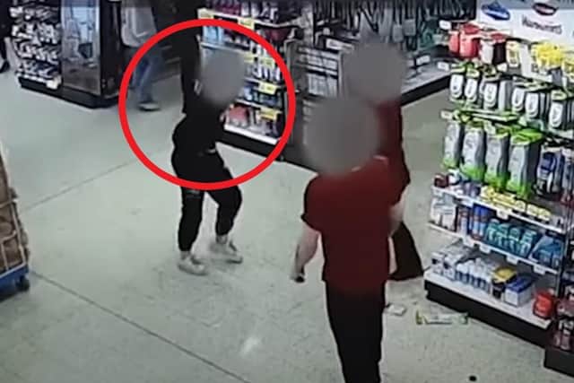 A still from the CCTV footage in Home Bargains just before the woman spits biscuits at a staff member.
