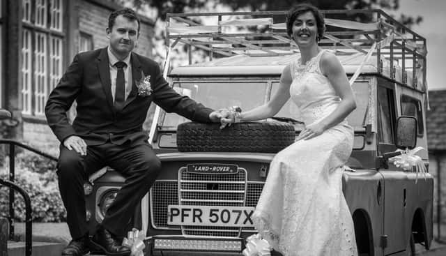 Jack and Kennedy pose on their Land Rover after the wedding.