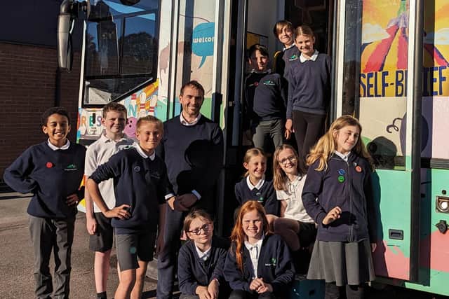 Anthony Tierney - headteacher with Y6 House Captains and the school reading bus. Photo submitted