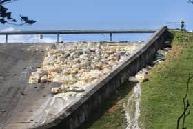 Engineers working on the wall after the spillway partially-collapsed in August last year
