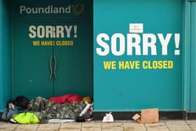 A homeless person sleeps in the doorway of a closed-down Poundland store in York, north west England on January 6, 2021, on the second day of Britain's national lockdown to combat the spread of COVID-19. - England went back into full lockdown as Europe battled Wednesday to stem a rising tide of coronavirus cases, and the United States logged its worst daily death toll of the pandemic. (Photo by Oli SCARFF / AFP) (Photo by OLI SCARFF/AFP via Getty Images)