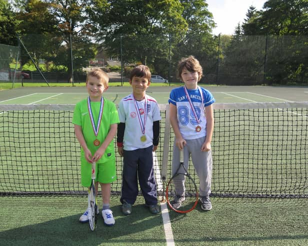 Three youngsters get ready to play at Buxton.