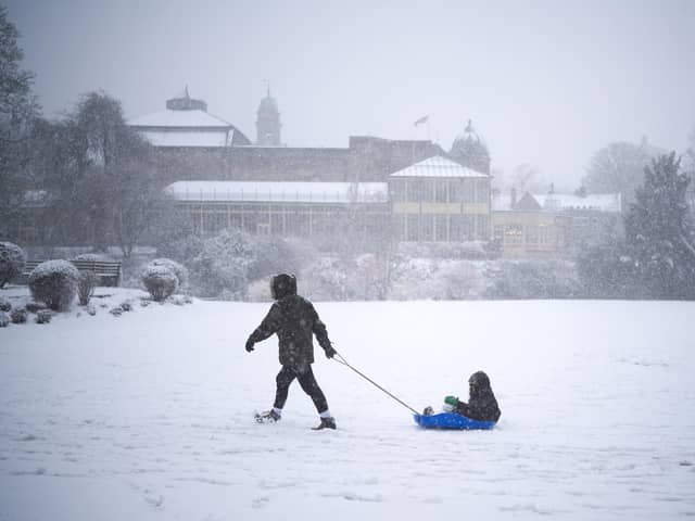 Being pulled on a sledge through the Pavilion Gardens (Photo by Christopher Furlong/Getty Images)