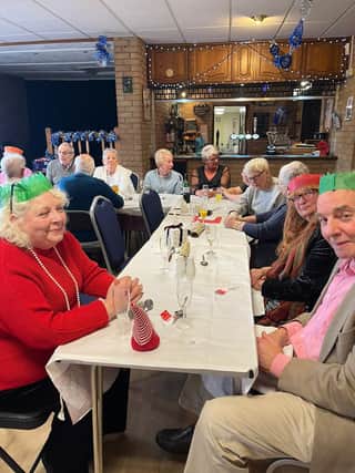 Some of the 72 residents who enjoyed a free Christmas meal in Dove Holes Community centre. Photo submitted